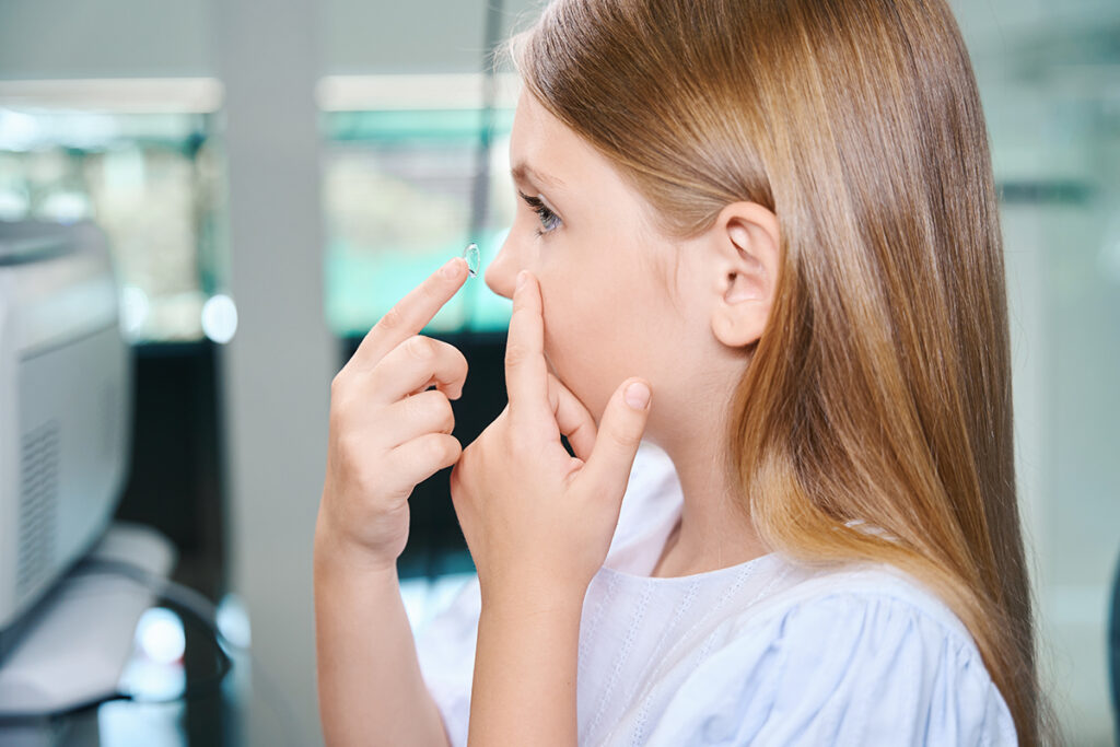 Girl practicing putting in contacts at Spacial Eyes Optical Contact Fitting Appointment