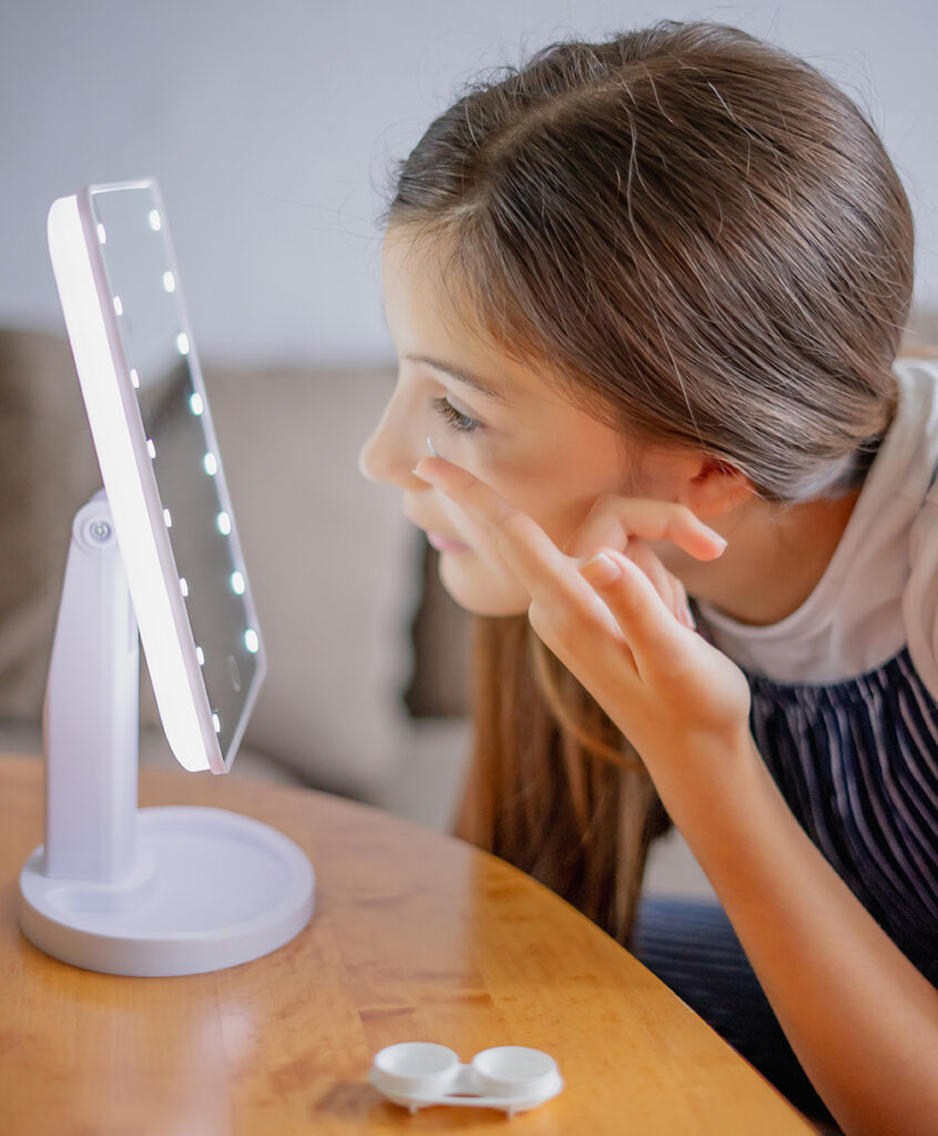 Girl putting in Contacts at Special Eyes Optical